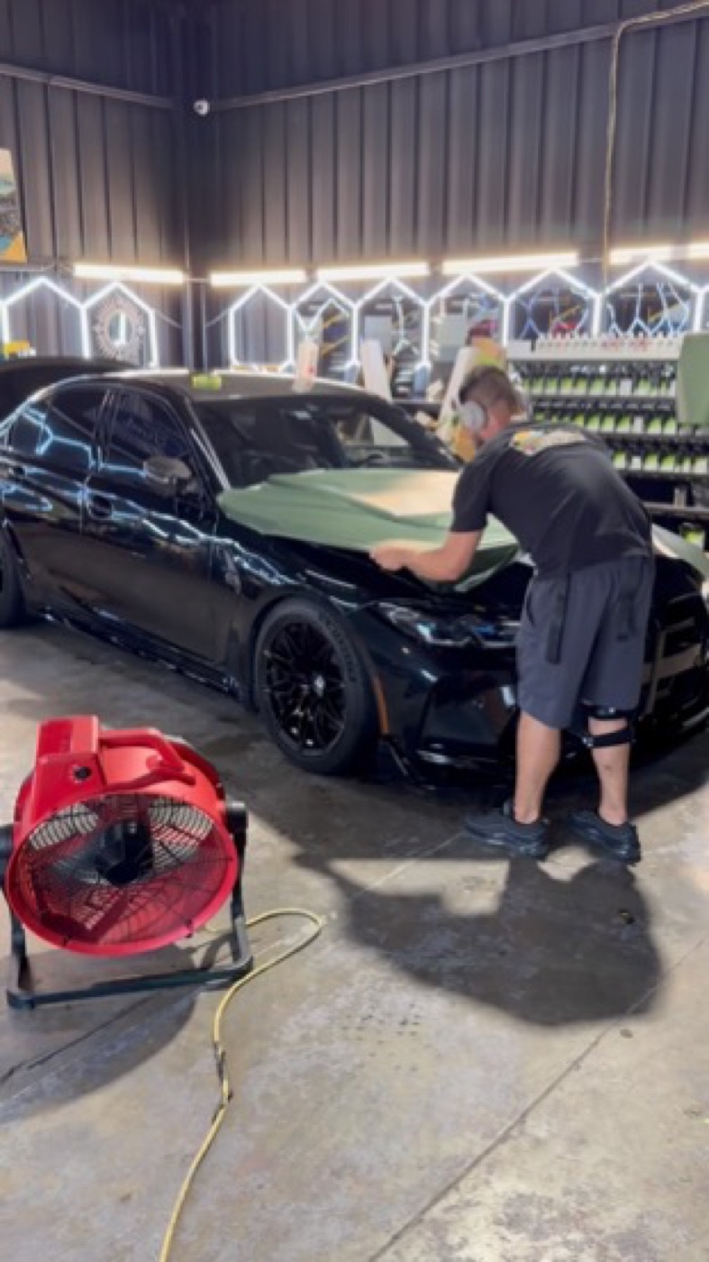 Gloss black over factory paint. BMW M4, mid-install. Corsa Automotive, Orlando.