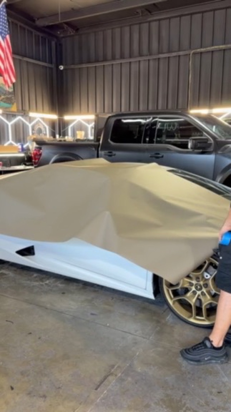 Laying a full panel. Corvette, single-piece pull. Corsa Automotive, Orlando.