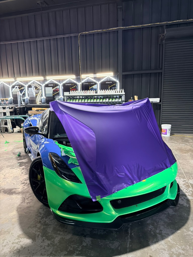 Purple over green. Lotus Emira, hood going on. Corsa Automotive, Orlando.